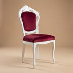 Angled view of handcrafted baroque Filipo dining chair Venezia in white wood and red velvet.